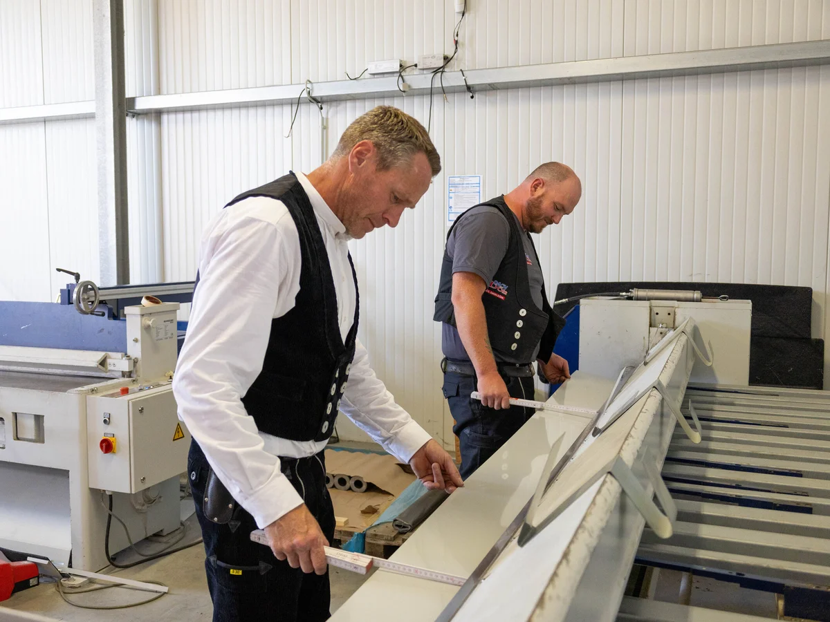 Mitarbeiter vermessen Blech an der Abkantbank